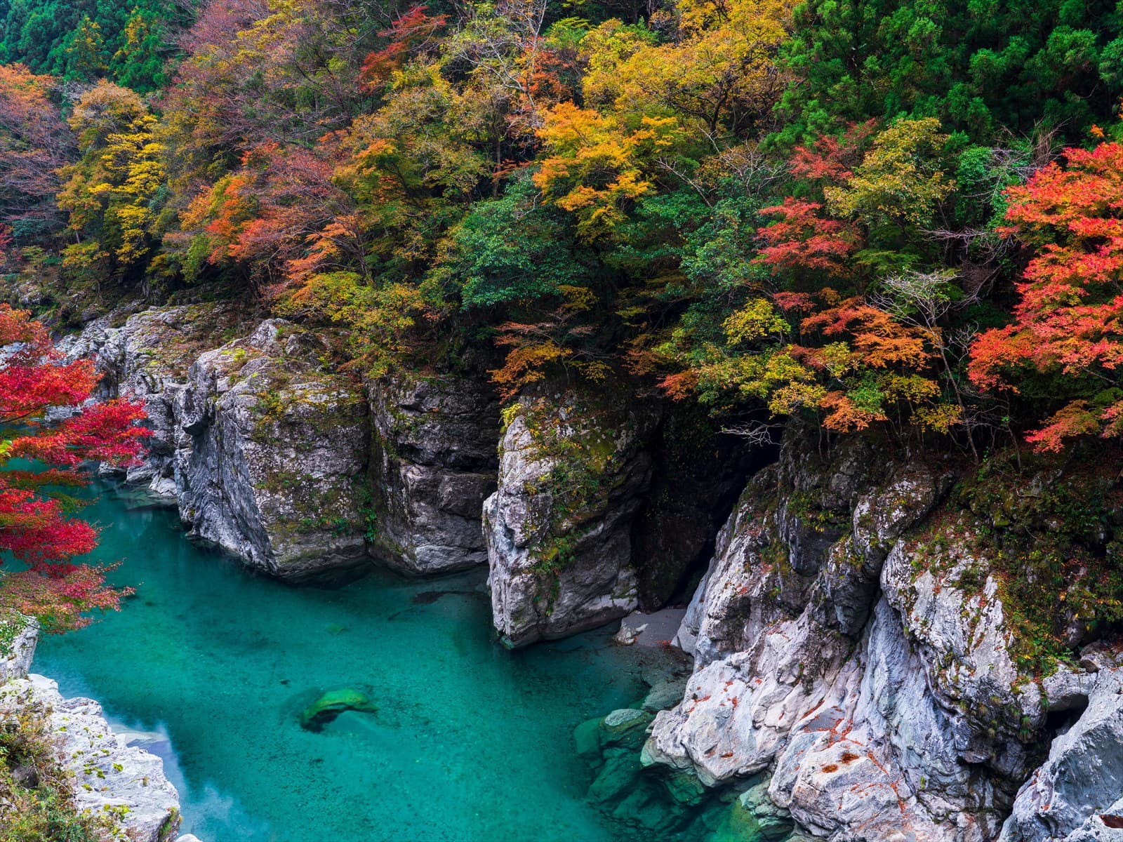 Oboke & Koboke Gorges in tokushima, Japan - Dramatic V-shaped gorges carved through crystalline rock formations along the Yoshino River, offering thrilling whitewater rafting and scenic boat tours through ancient geological wonders.