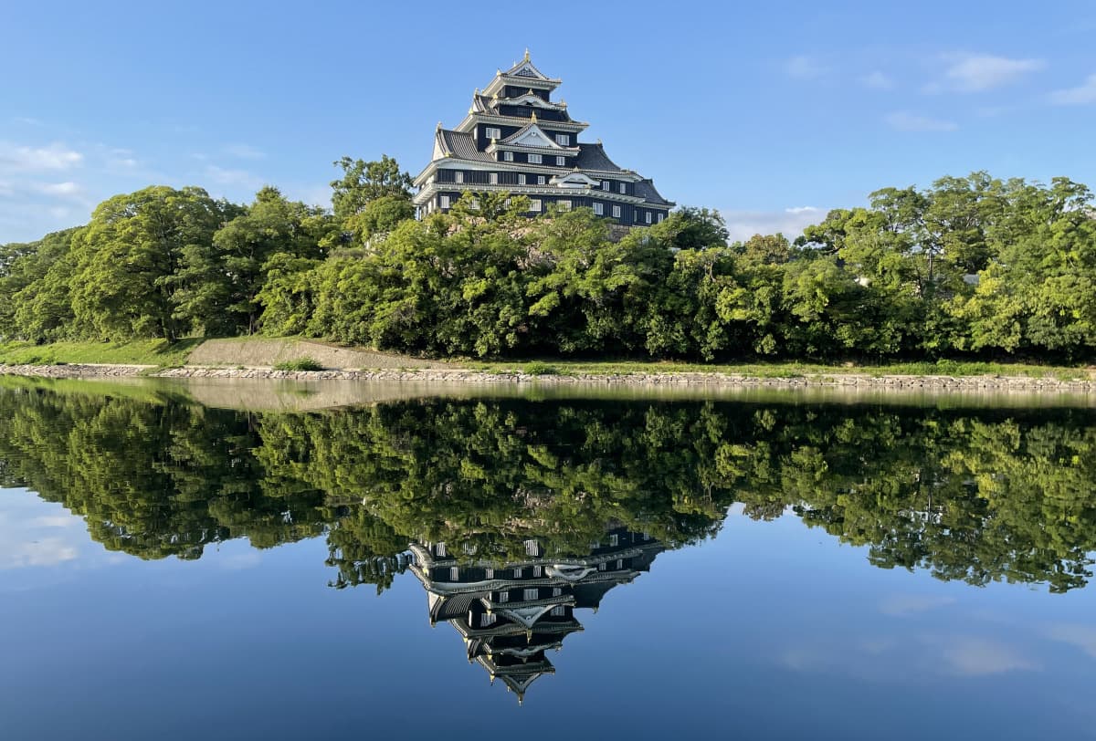 Okayama Castle in okayama, Japan - Distinctive black castle nicknamed 'Crow Castle' featuring reconstructed donjon, samurai exhibits, and riverside location next to Korakuen Garden.