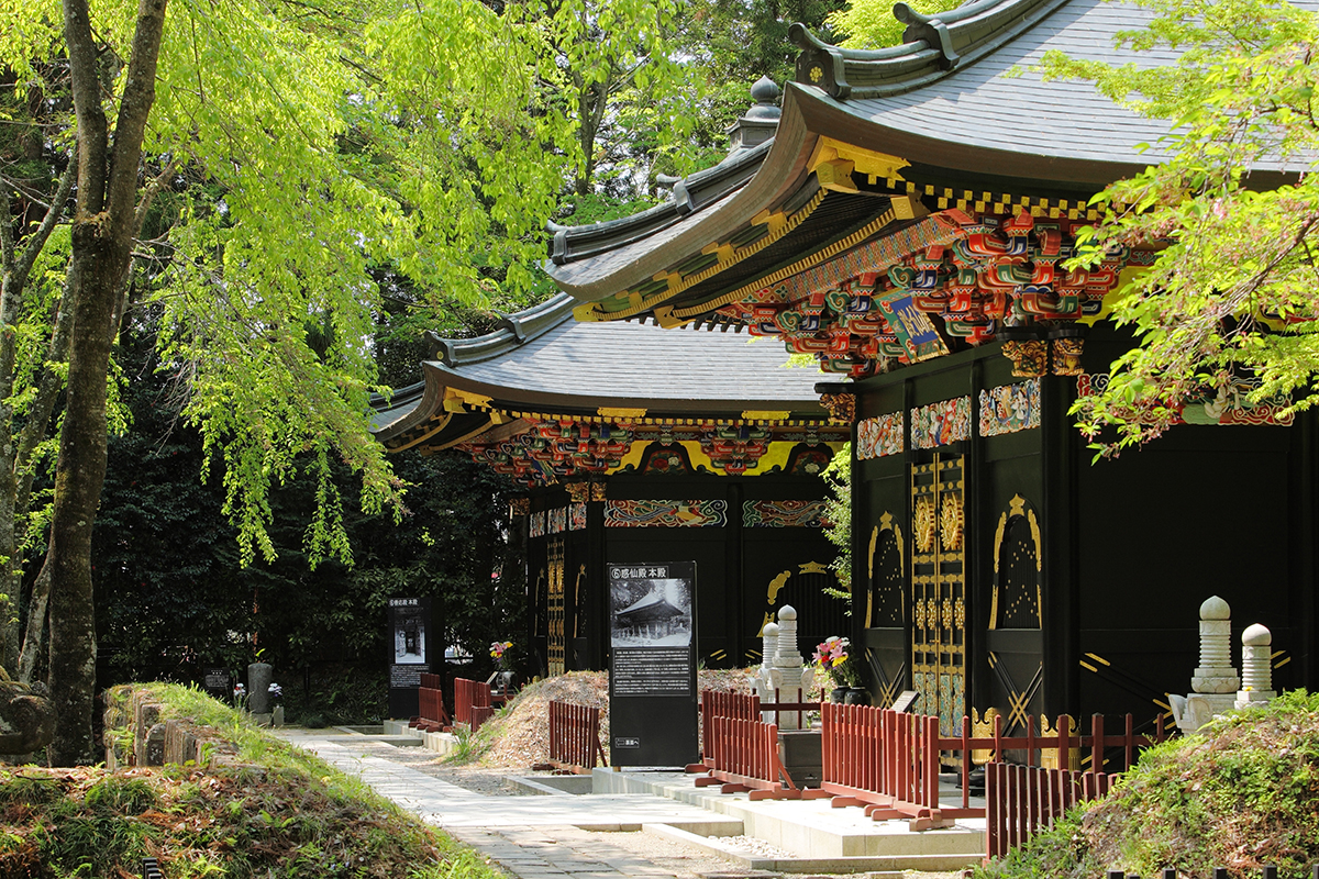 Zuihoden Mausoleum in miyagi, Japan - The ornate mausoleum of Date Masamune featuring brilliant Momoyama-period architecture with black lacquer, gold leaf decoration, and vivid colors in a serene cedar forest setting.